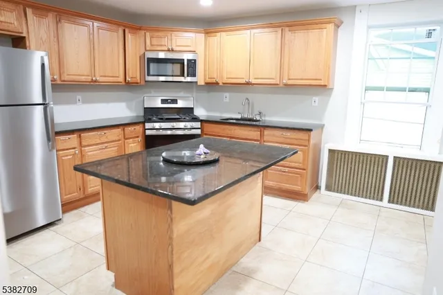 a view of an empty room with wooden floor and closet