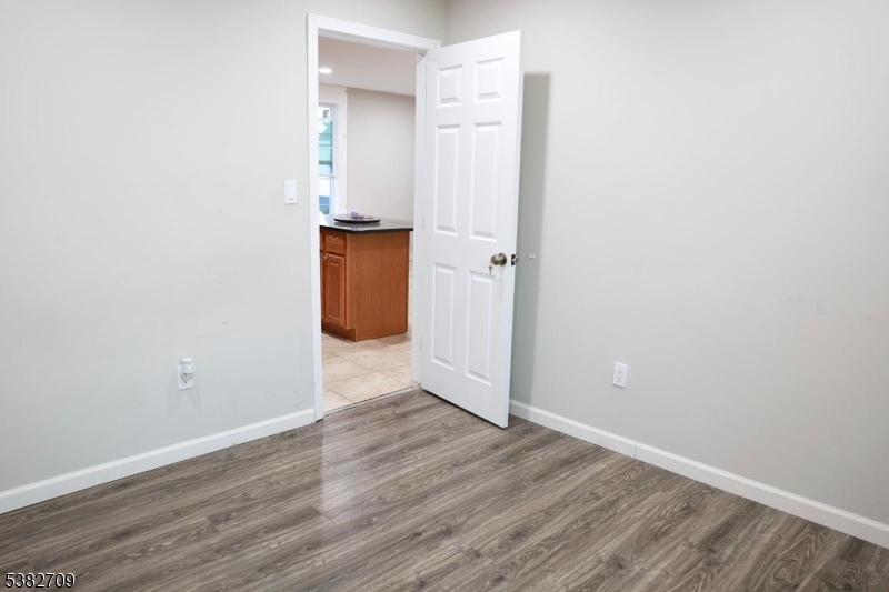 237 Haledon Avenue Haledon, NJ 07508 - Photo 32 of 49 an empty room with wooden floor
