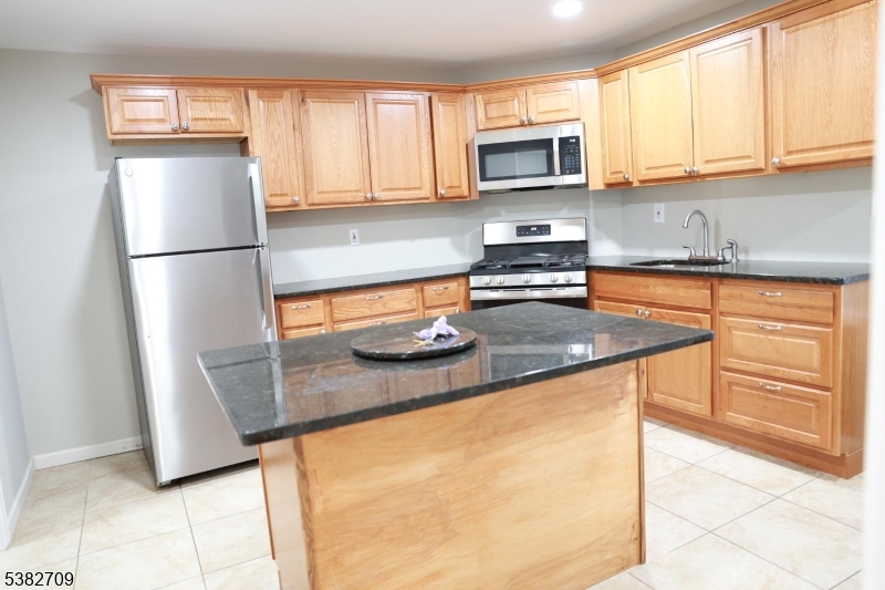 237 Haledon Avenue Haledon, NJ 07508 - Photo 33 of 49 a kitchen with stainless steel appliances granite countertop a refrigerator a stove a sink and a window