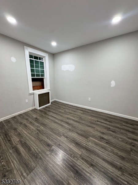 237 Haledon Avenue Haledon, NJ 07508 - Photo 34 of 49 an empty room with wooden floor and windows