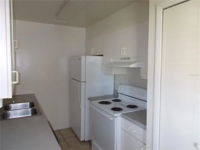 a kitchen with a refrigerator sink and stove