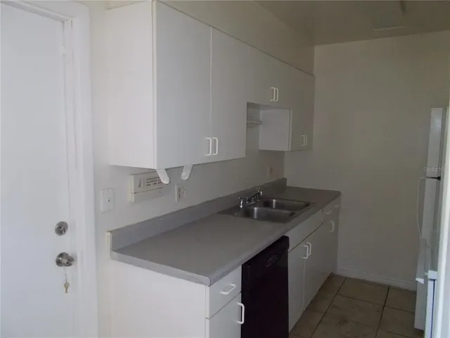 a room with a sink and cabinets