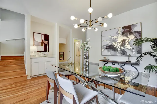 a living room with furniture a fireplace and a floor to ceiling window