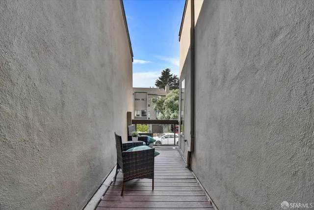 a living room with furniture a fireplace a rug and a window