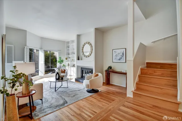 a living room with furniture and a potted plant