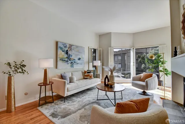 a dining room with furniture potted plants and wooden floor