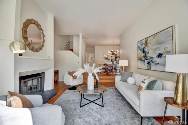 a dining room with furniture a chandelier and wooden floor