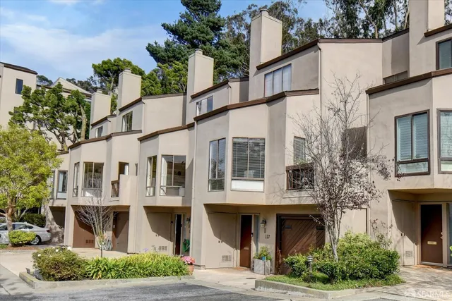 a front view of a building with a garden