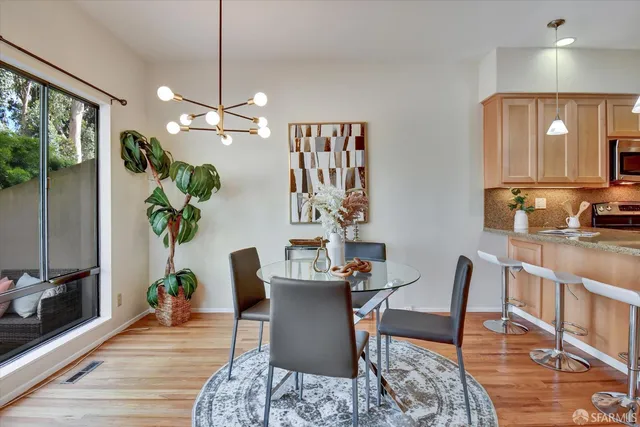 a kitchen with granite countertop a stove a sink and a microwave