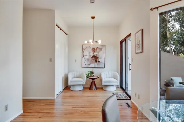a kitchen with a granite counter top a potted plant on the counter and cabinets