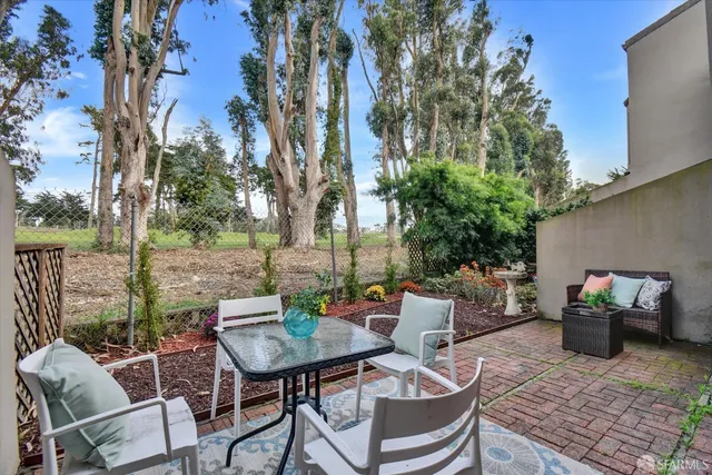 a kitchen with granite countertop white cabinets stove and sink
