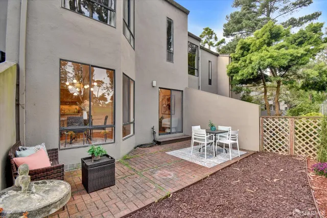 a bedroom with bed and a large window