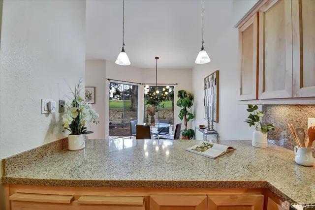 a view of hallway with window and wooden floor