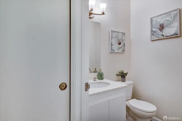 a bedroom with a bed and a lamp on dresser