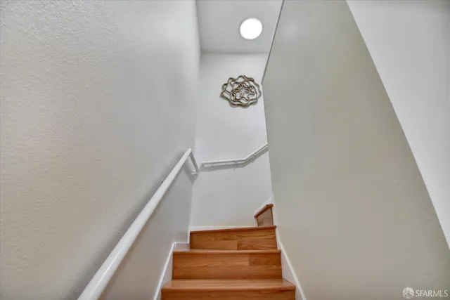 a bathroom with a granite countertop sink toilet a large mirror a shower and a mirror