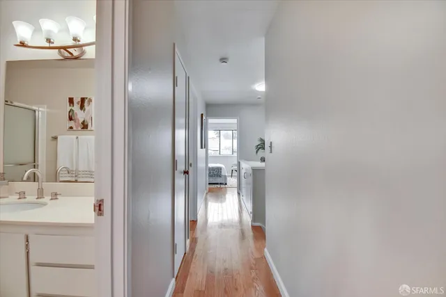 a bedroom with a large bed and a potted plant
