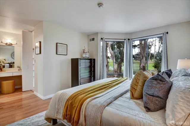 a view of a street with a houses in the background