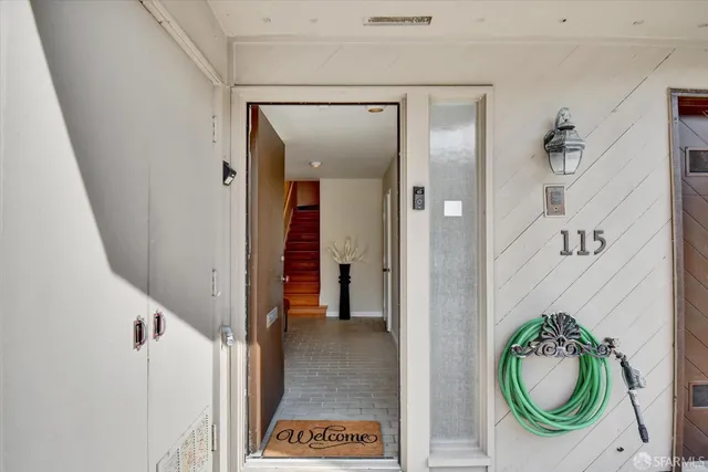 a view of a dining room with furniture a chandelier and wooden floor