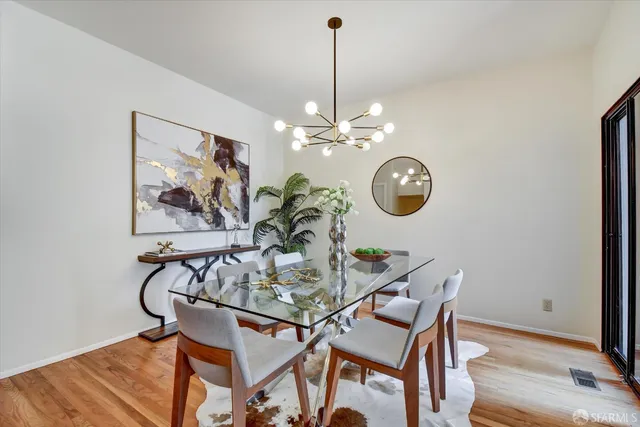 a balcony with wooden floor and bench
