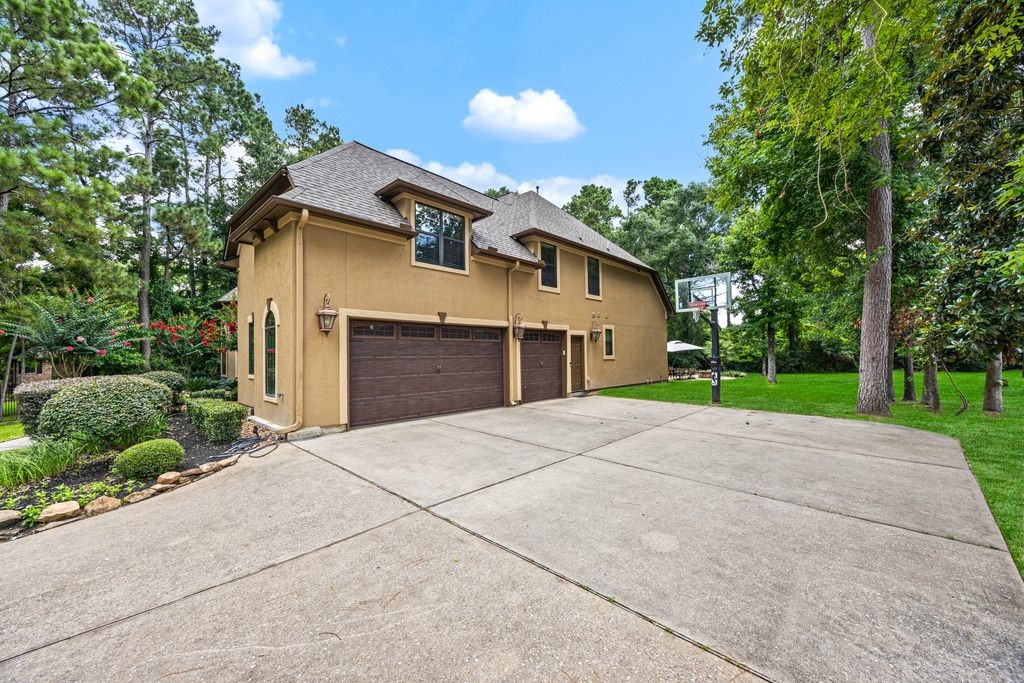 27722 Tiverton Court Spring, TX 77386 - Photo 30 of 33 Exceptional Parking & Storage: The oversized three-car garage, paired with an expansive double driveway, provides abundant space for vehicles, hobbies, storage, and guests with ease and convenience.