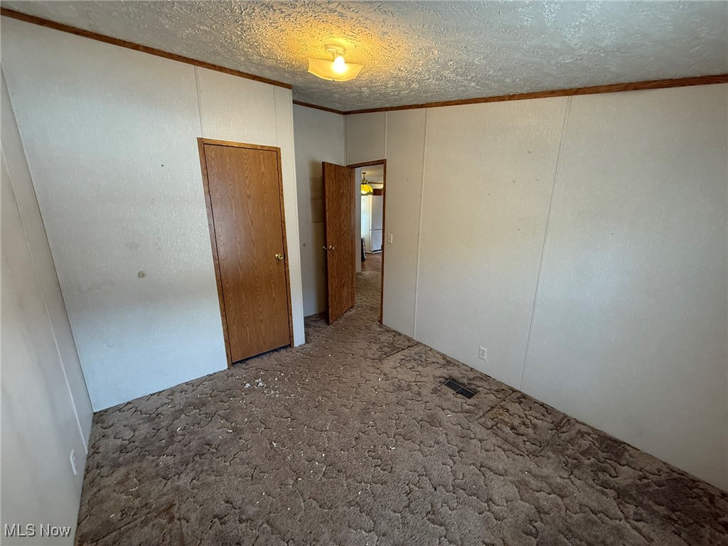 83631 Merryman Road Cadiz, OH 43907 - Photo 7 of 16 Empty room featuring a textured ceiling