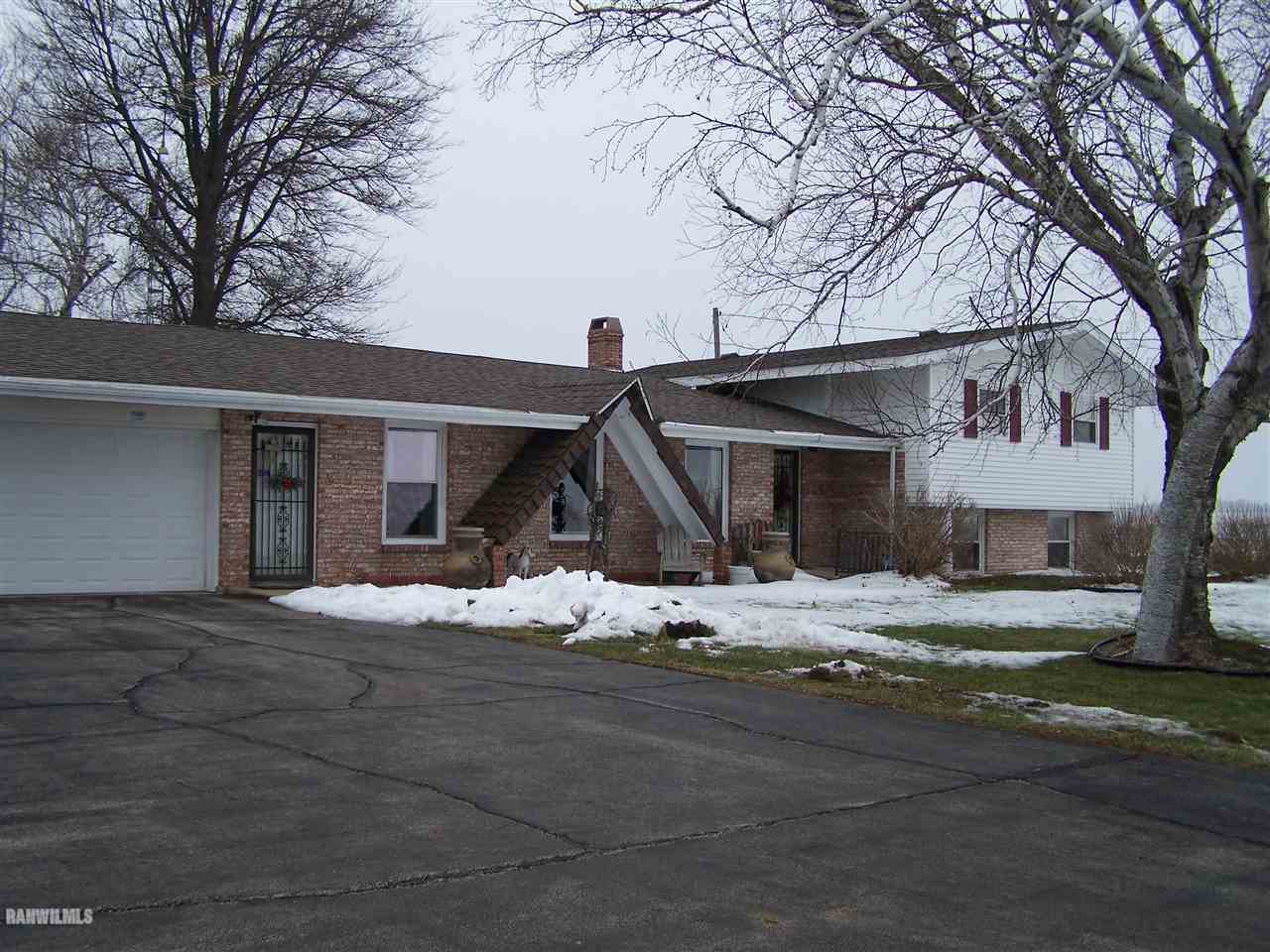 9554 Preston Road Mount Carroll, IL 61053 - Photo 1 of 17 a view of a house with a yard covered in snow