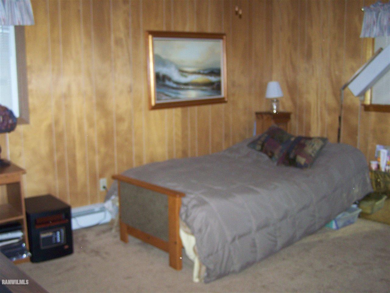 9554 Preston Road Mount Carroll, IL 61053 - Photo 13 of 17 a bedroom with a bed and a chair