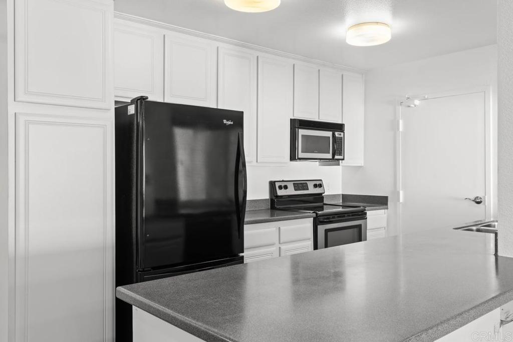 13544 Comuna Drive Poway, CA 92064 - Photo 11 of 41 a kitchen with a refrigerator and a stove top oven
