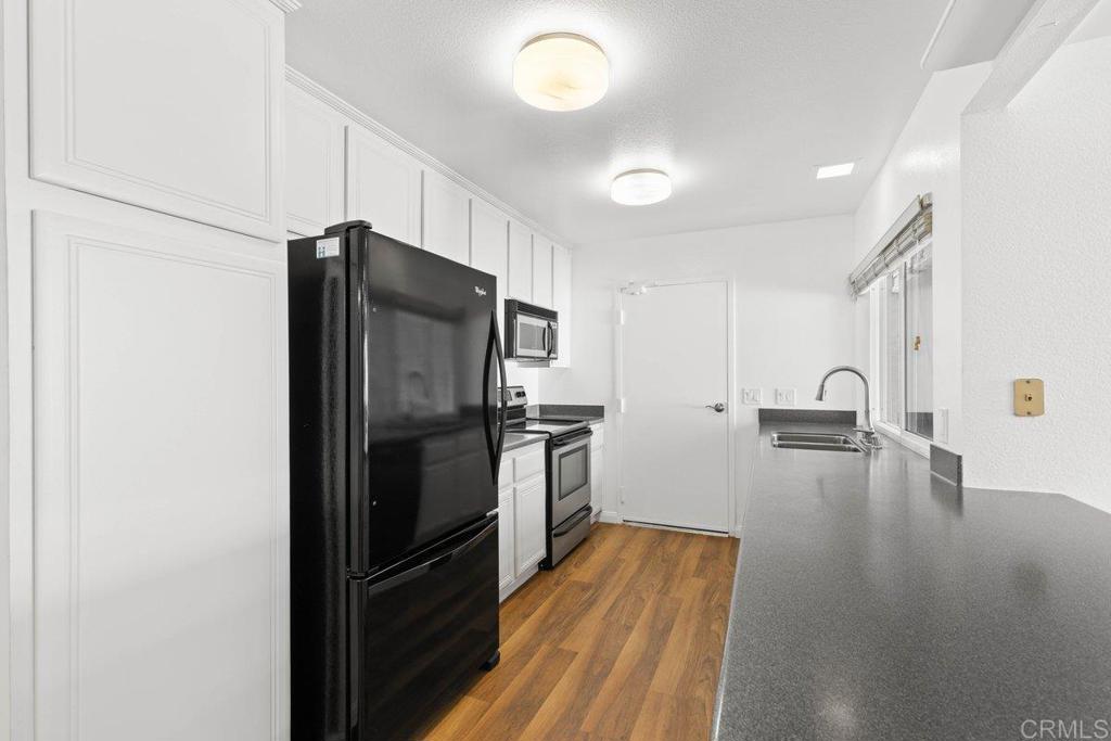 13544 Comuna Drive Poway, CA 92064 - Photo 12 of 41 a kitchen with a refrigerator and a sink