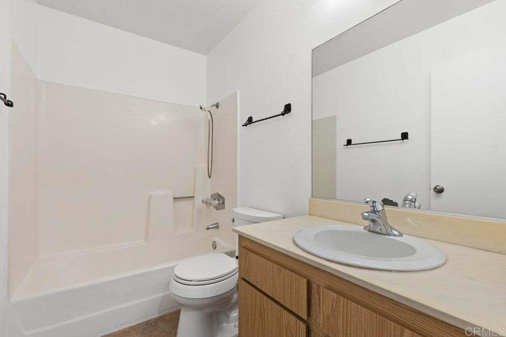 13544 Comuna Drive Poway, CA 92064 - Photo 20 of 41 a bathroom with a sink toilet vanity and shower