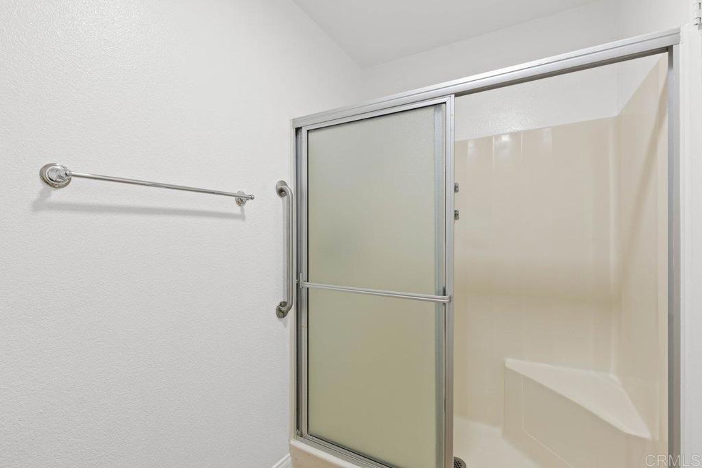 13544 Comuna Drive Poway, CA 92064 - Photo 27 of 41 a bathroom with a glass shower door