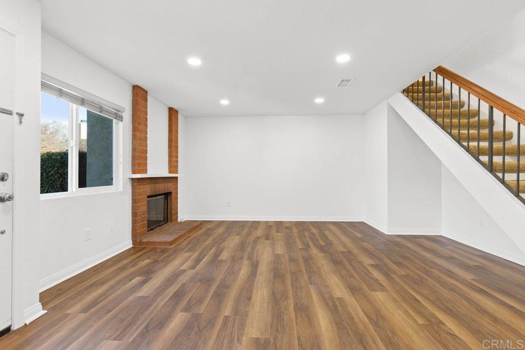 13544 Comuna Drive Poway, CA 92064 - Photo 7 of 41 a view of empty room with wooden floor and fan