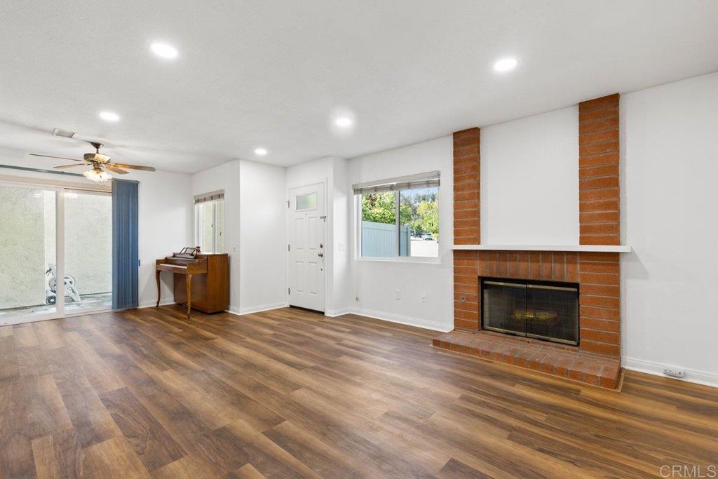 13544 Comuna Drive Poway, CA 92064 - Photo 9 of 41 a view of empty room with wooden floor and fireplace