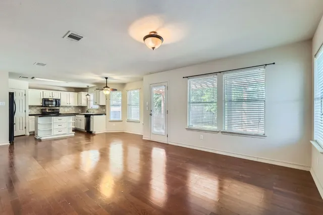 a view of kitchen with livingroom and wooden floor