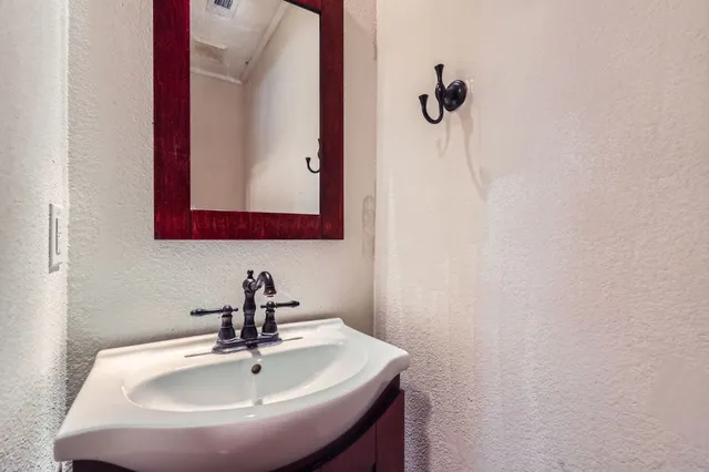 a bathroom with a sink and mirror