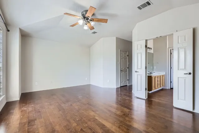 a view of an empty room and wooden floor