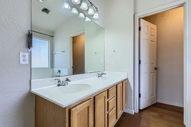 a bathroom with a sink a mirror and a shower
