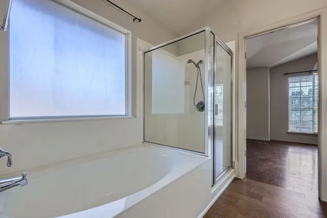 a bathroom with a shower and a tub