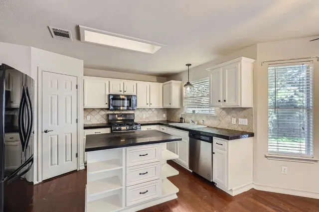 a kitchen with a refrigerator stove and sink
