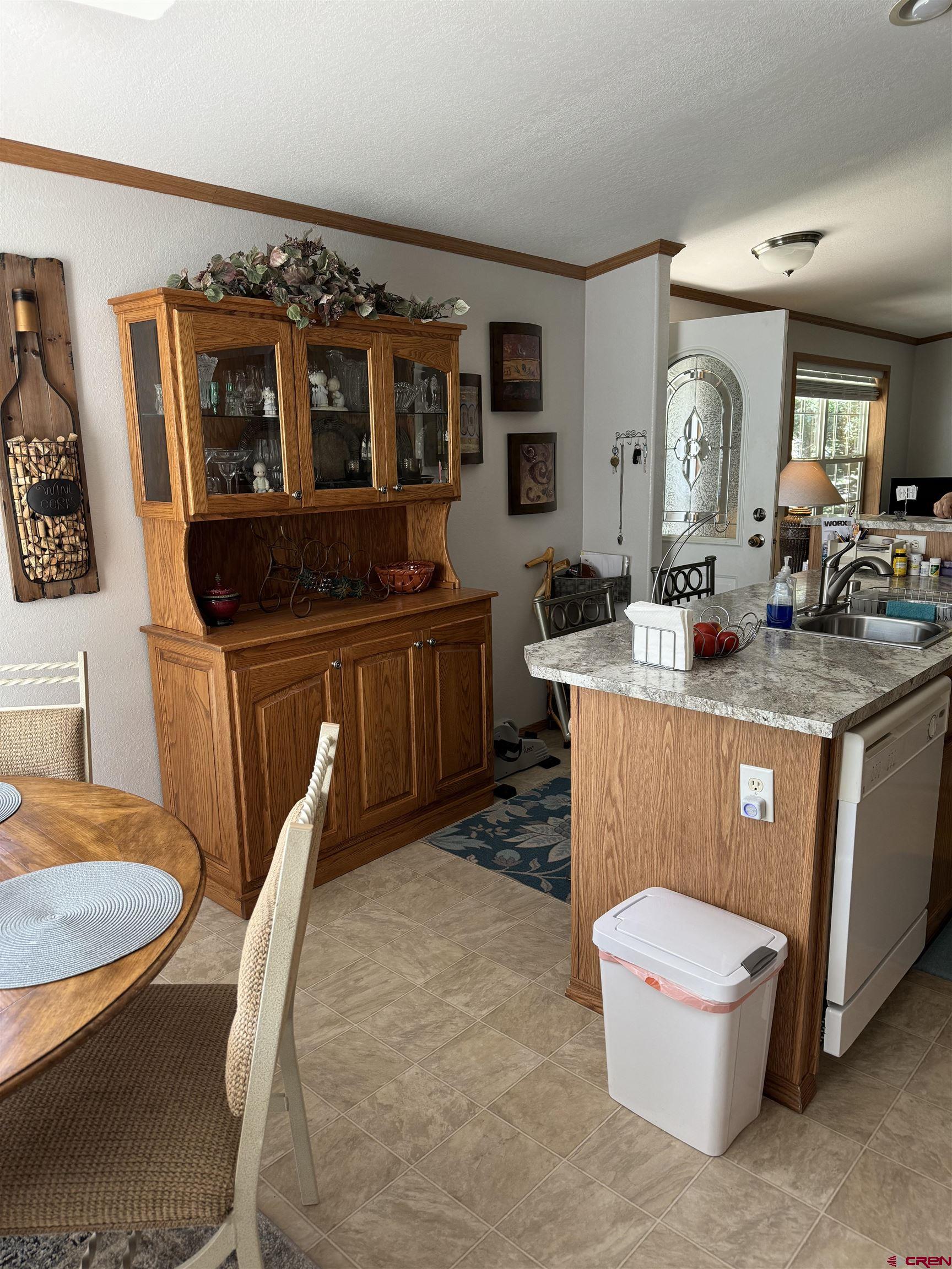 901 6530 Road, Unit 1307 Montrose, CO 81401 - Photo 3 of 14 a living room with stainless steel appliances granite countertop a sink a microwave a dining table and chairs