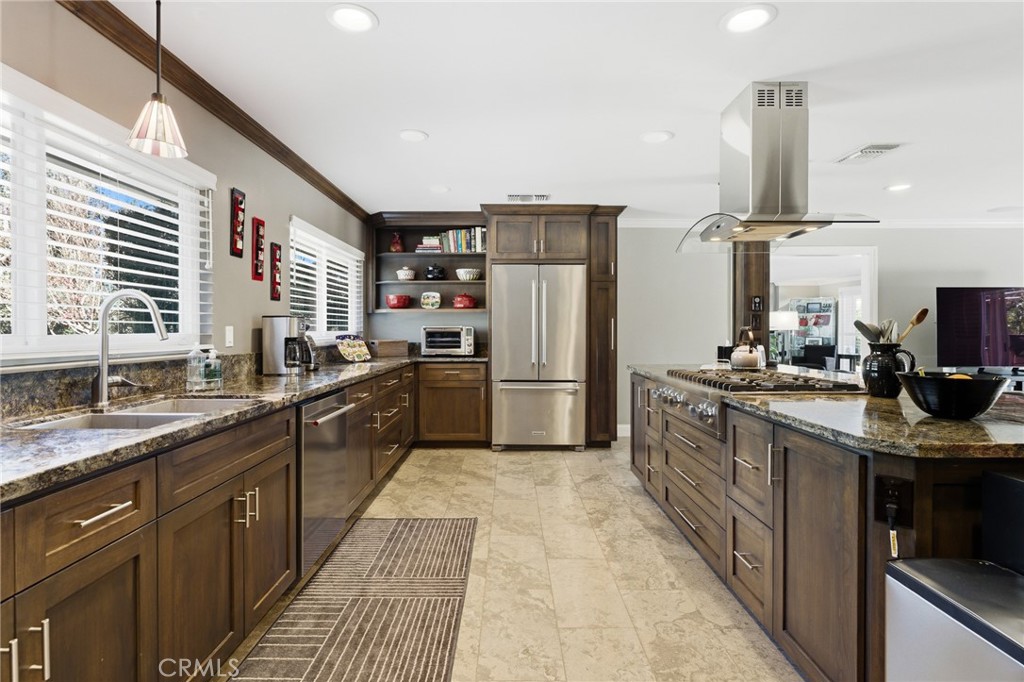 1805 Canyon Road Redlands, CA 92373 - Photo 19 of 61 a kitchen with stainless steel appliances granite countertop a sink counter space cabinets a stove and a window