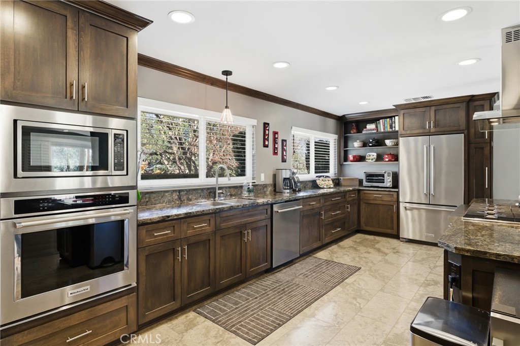 1805 Canyon Road Redlands, CA 92373 - Photo 21 of 61 a kitchen with stainless steel appliances granite countertop a stove top oven a sink and a refrigerator