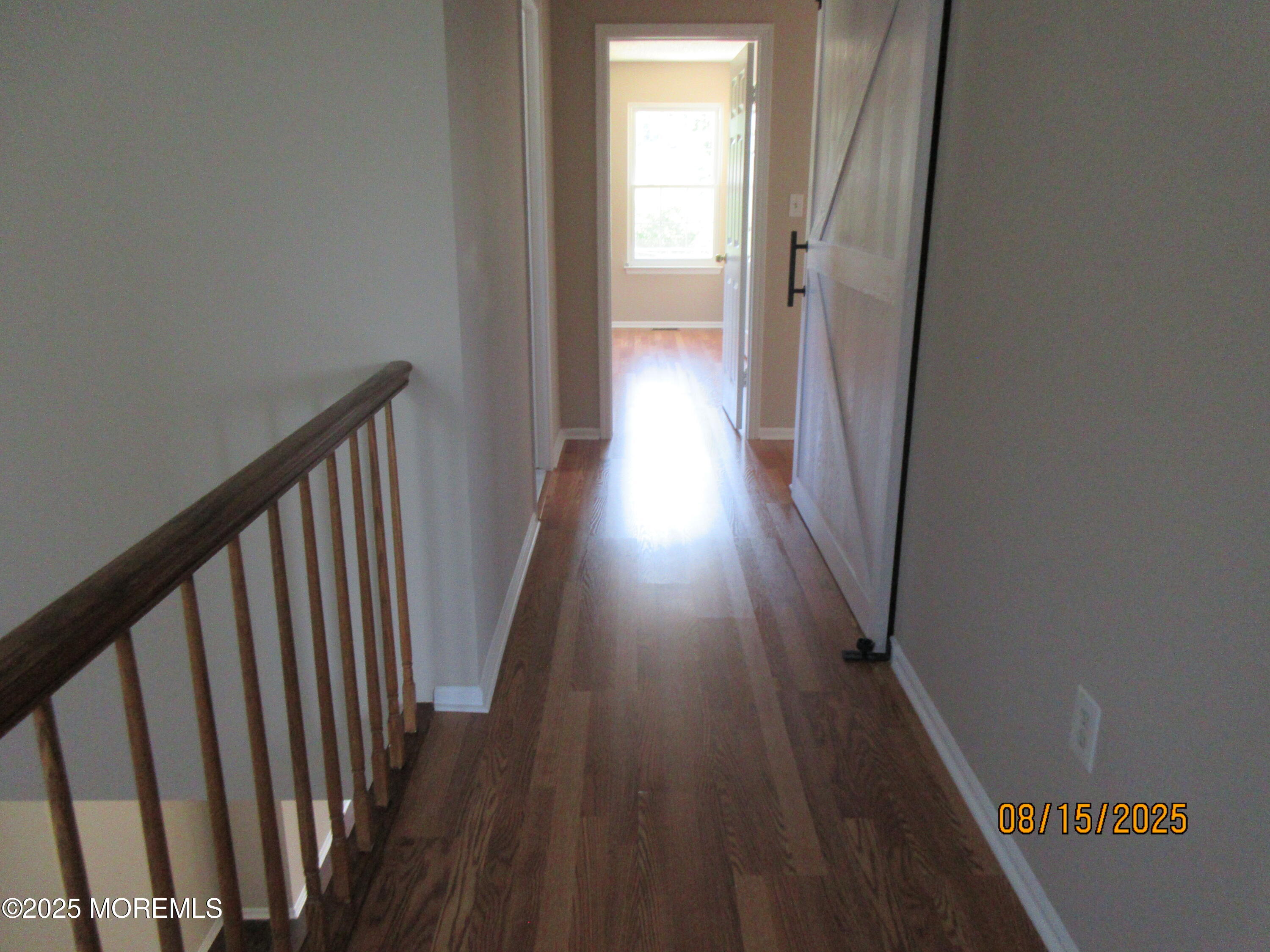 29 Longbrook Lane Freehold, NJ 07728 - Photo 13 of 40 a view of a hallway with wooden floor and staircase