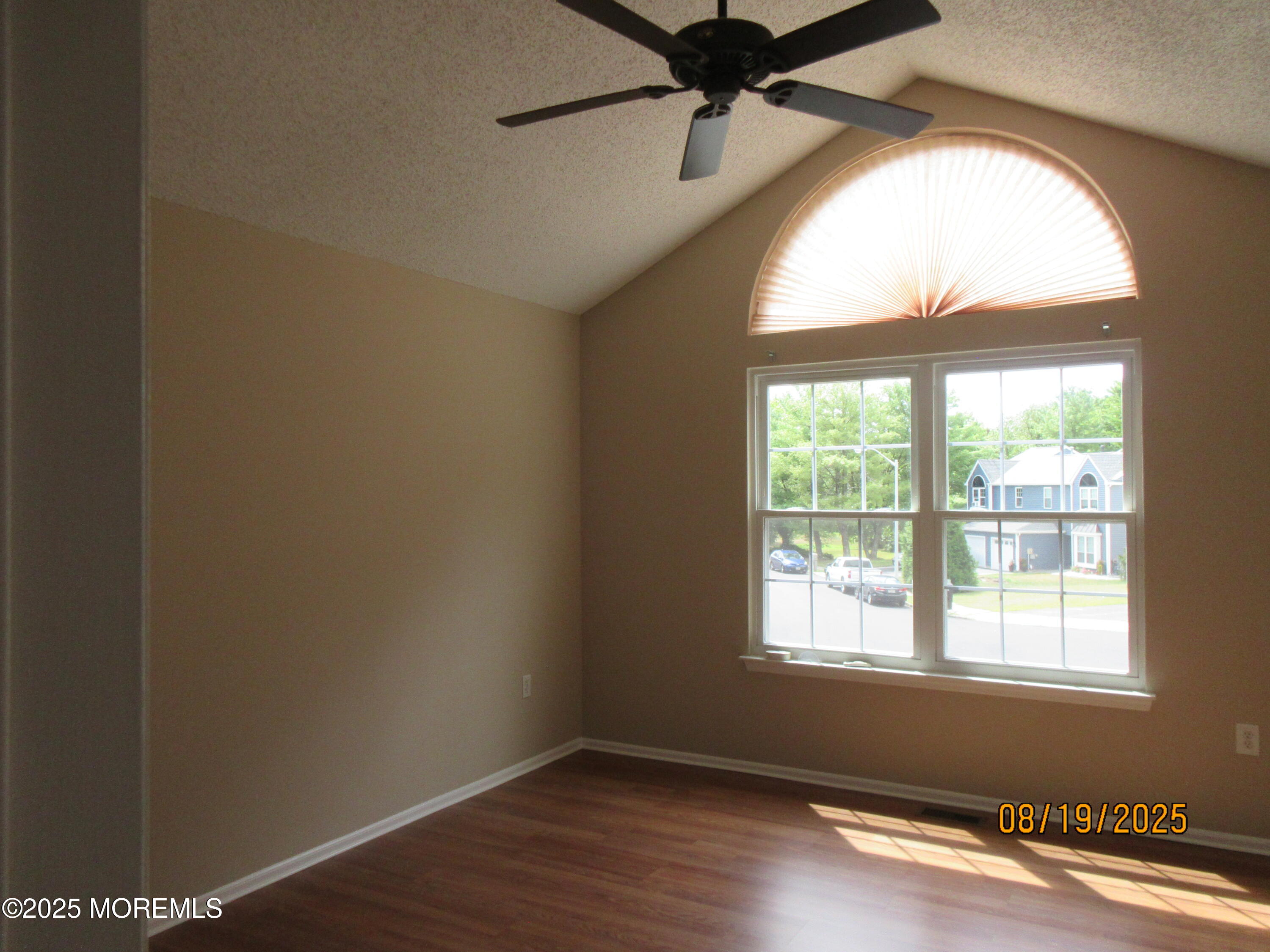 29 Longbrook Lane Freehold, NJ 07728 - Photo 16 of 40 an empty room with wooden floor fan and windows