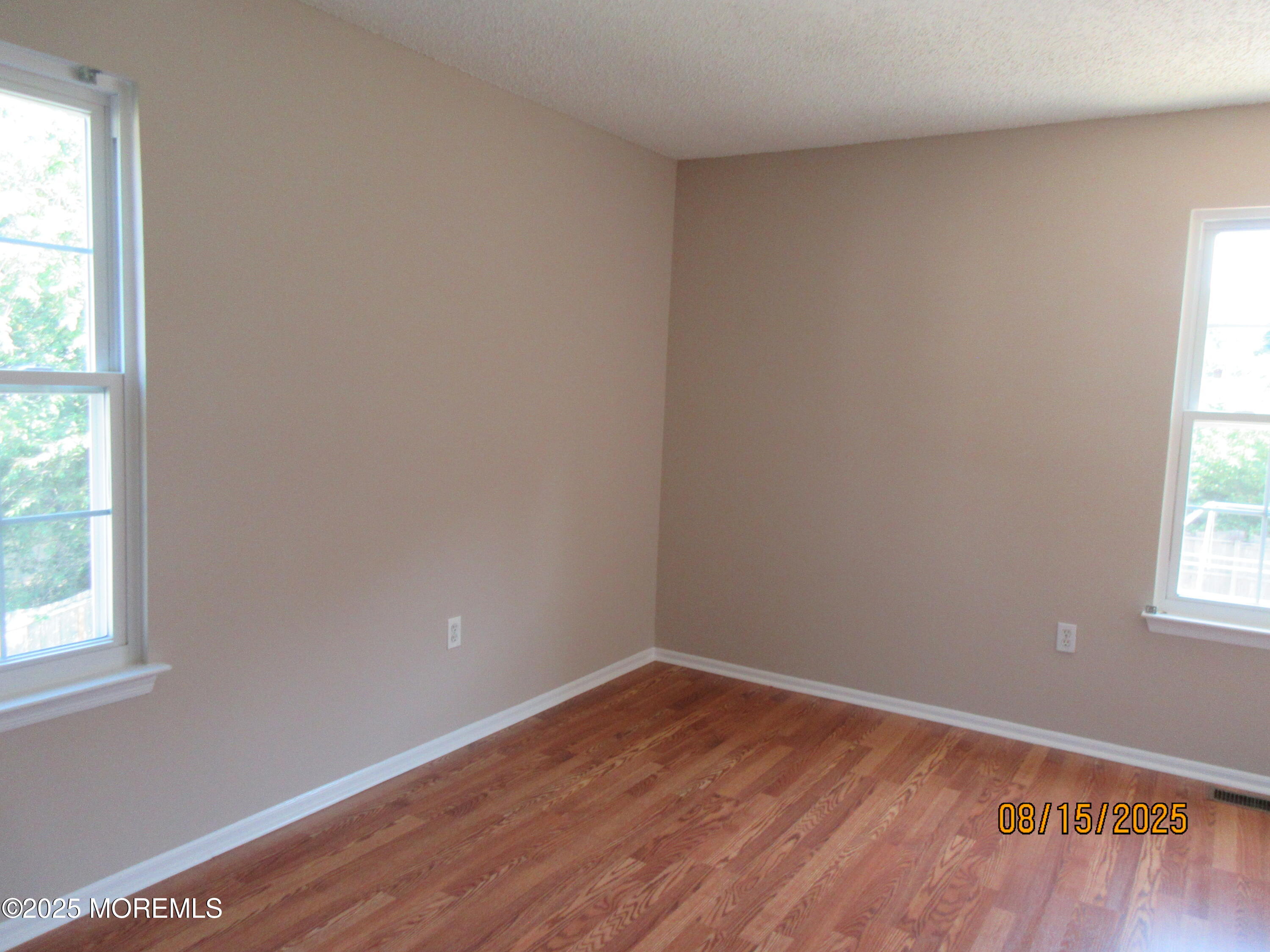 29 Longbrook Lane Freehold, NJ 07728 - Photo 25 of 40 an empty room with wooden floor and windows