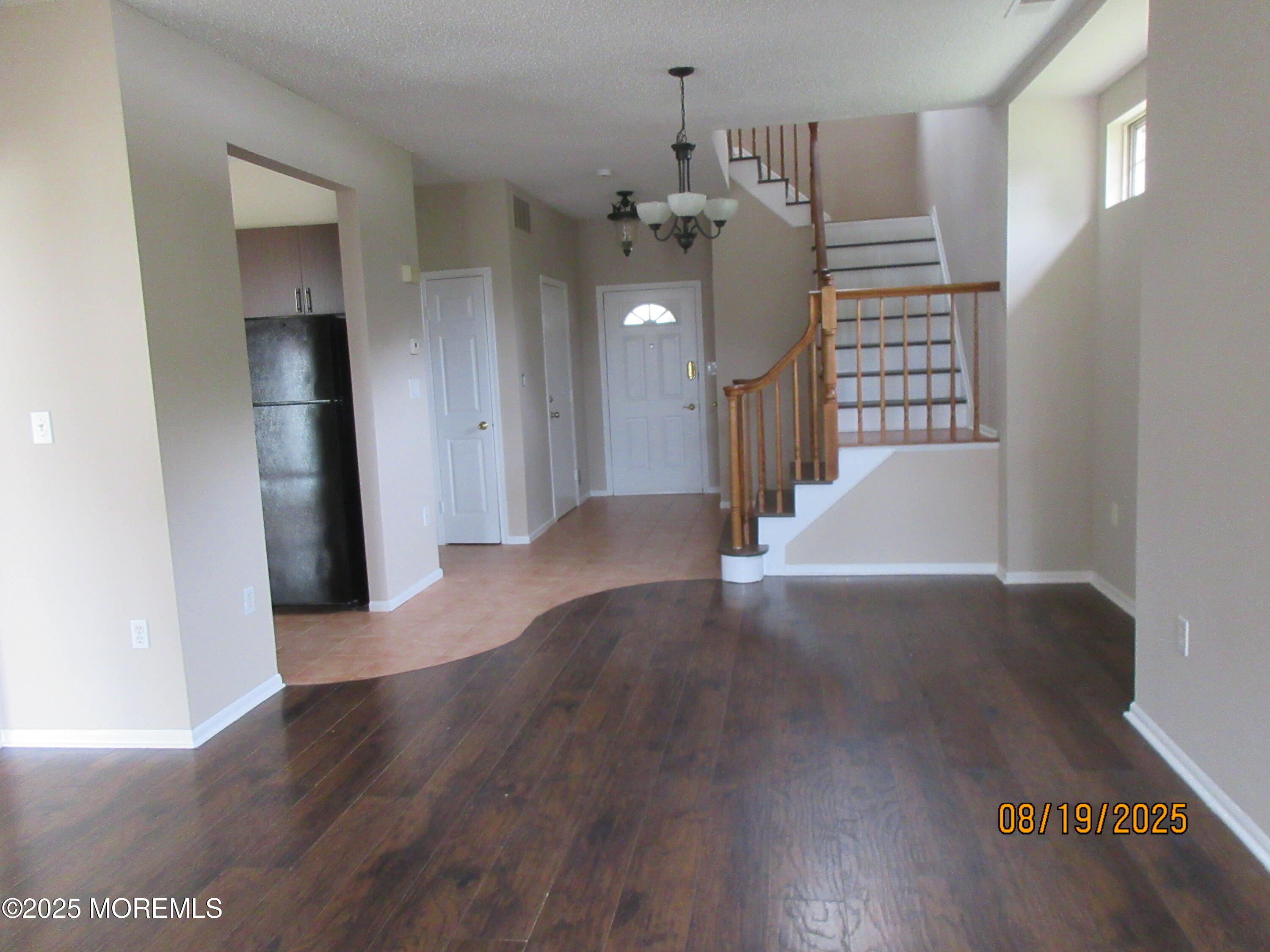 29 Longbrook Lane Freehold, NJ 07728 - Photo 3 of 40 a view of a livingroom with wooden floor and stairs