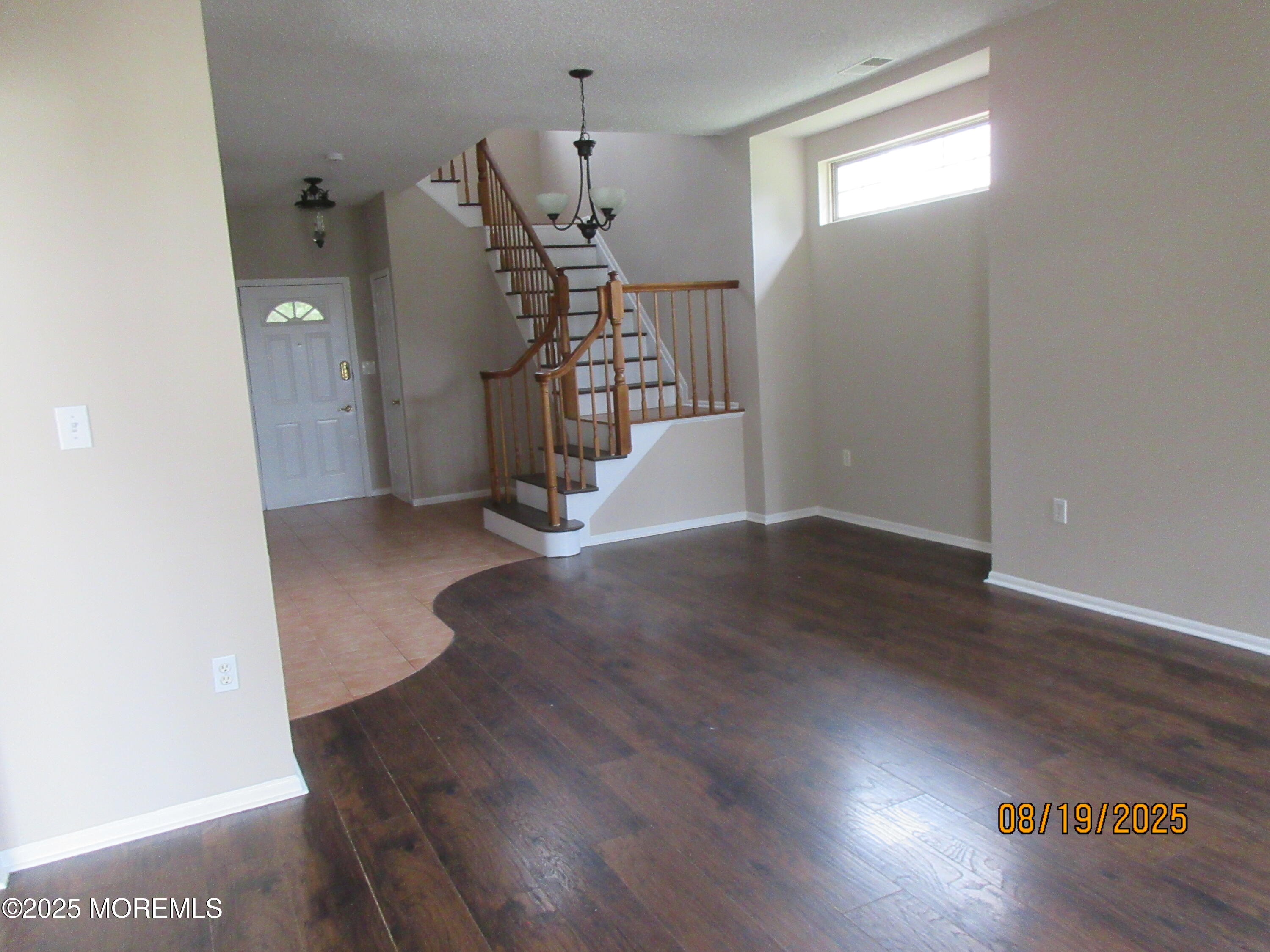 29 Longbrook Lane Freehold, NJ 07728 - Photo 4 of 40 a view of empty room with wooden floor and stairs