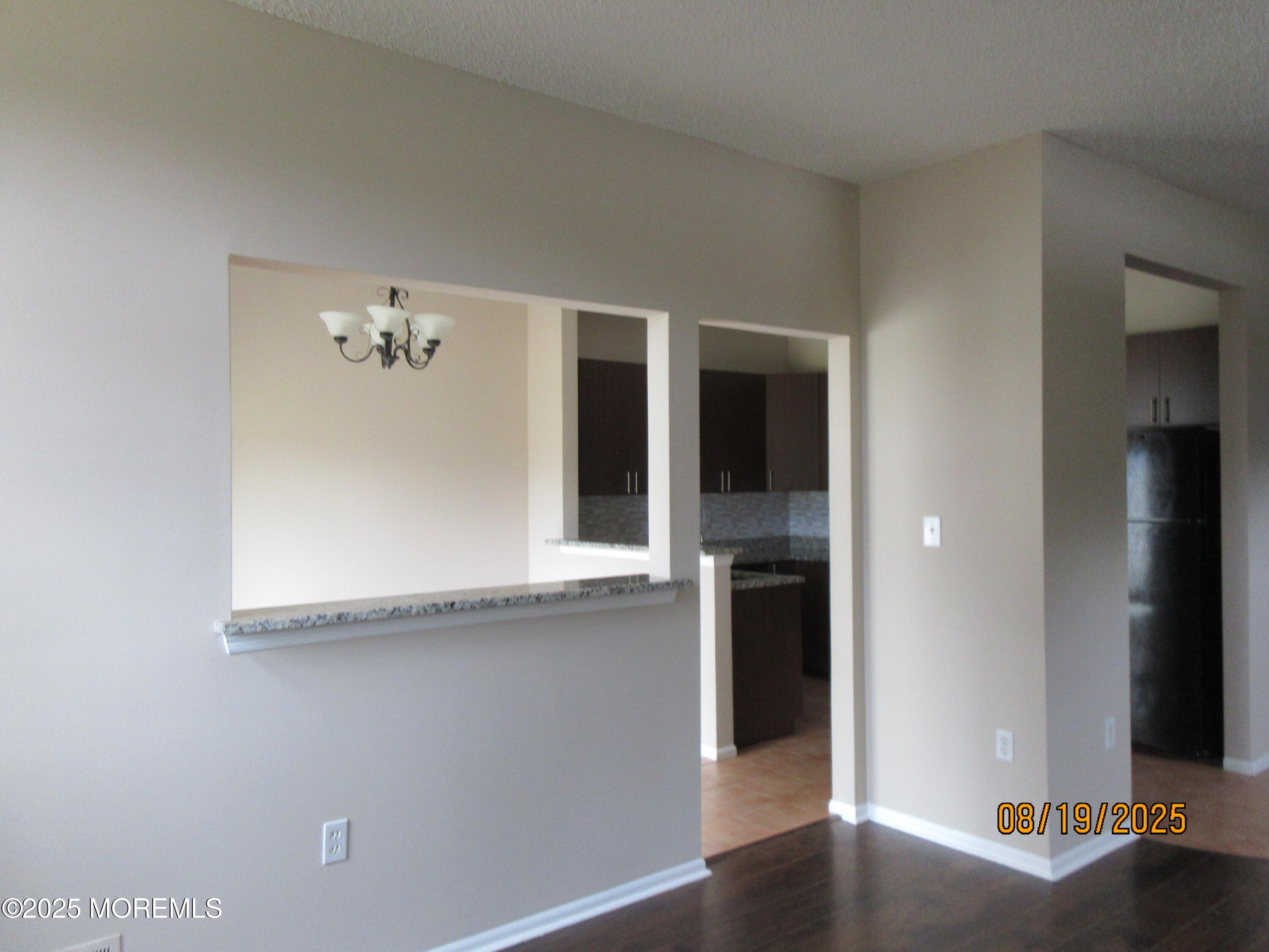 29 Longbrook Lane Freehold, NJ 07728 - Photo 5 of 40 an empty room with wooden floor and cabinet