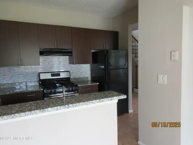a kitchen with a refrigerator sink and stove