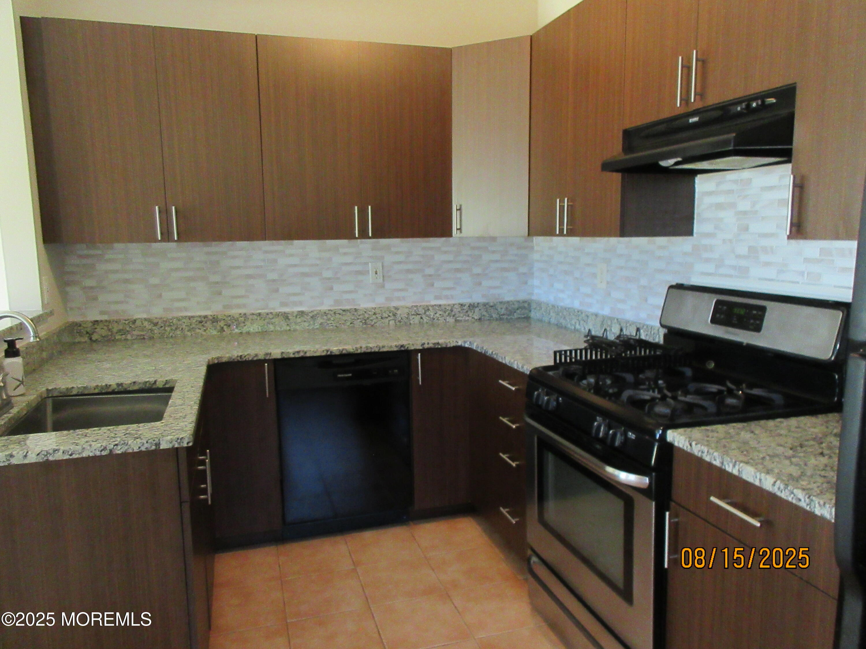 29 Longbrook Lane Freehold, NJ 07728 - Photo 7 of 40 a kitchen with granite countertop a stove and a sink